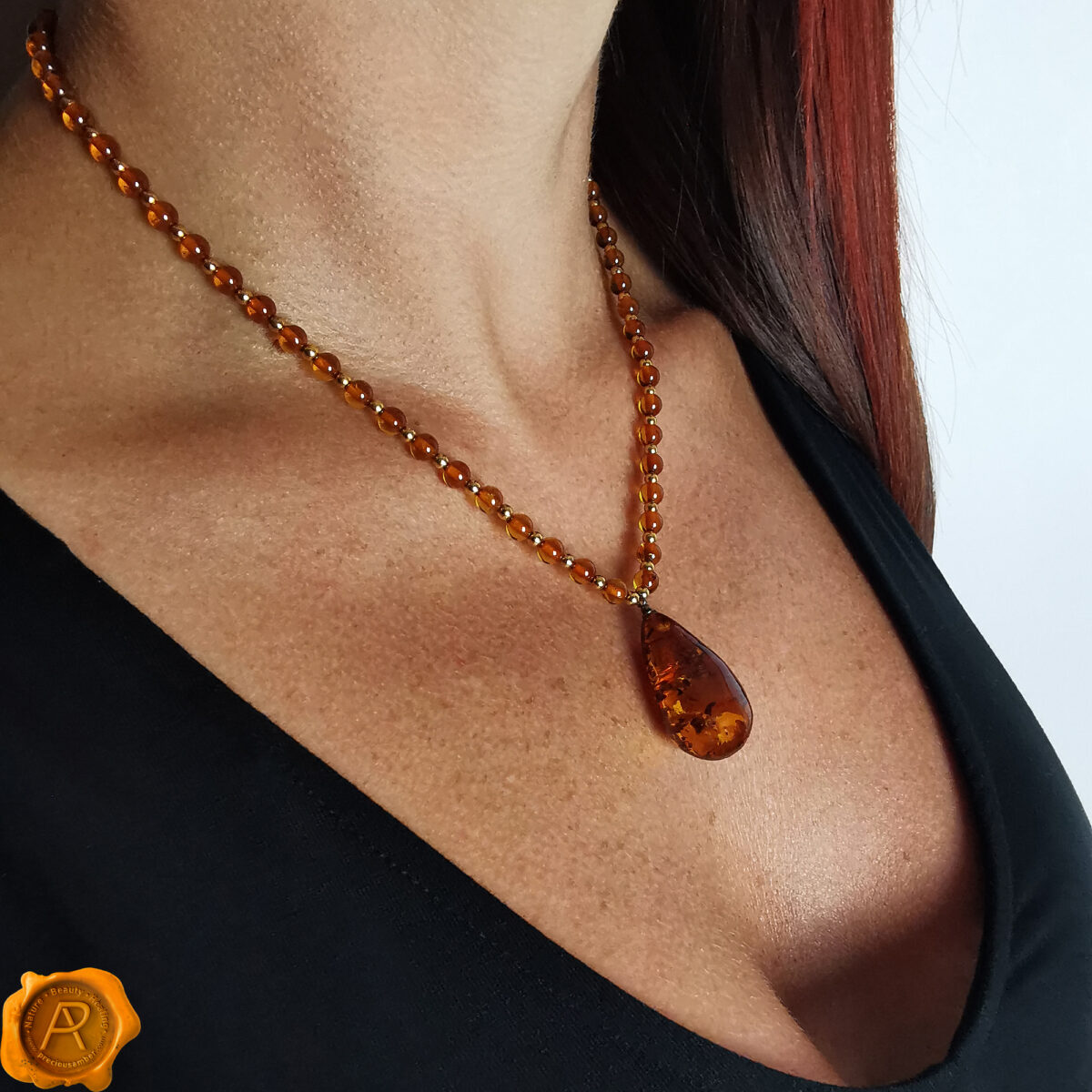 Large-Cognac-Baltic-Amber-Bead-Long-Gemstone-Teardrop-Gold-Pendant-Necklace-for-Women Amber Gold Teardrop Necklace - Image 2