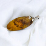 Luxurious Carved Amber Celestial Pendant - Image 4