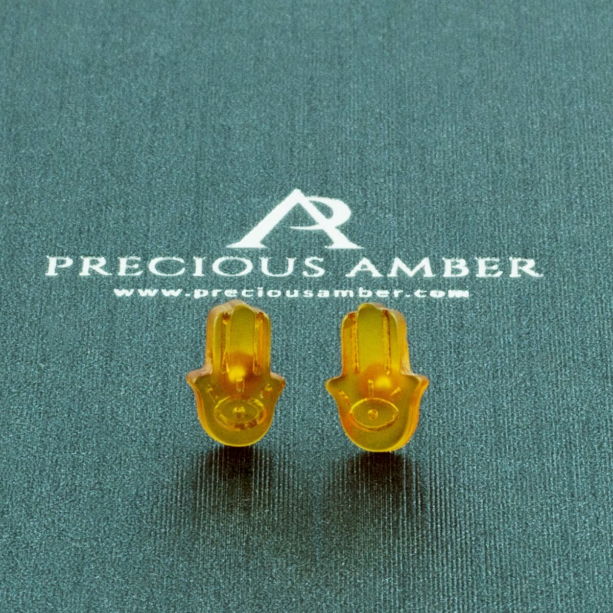 Carved Amber Hamsa Hand Stud Earrings - Image 1