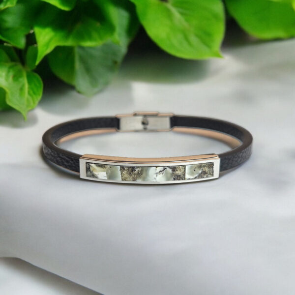 A striking fusion of elegance and edge, designed for those who value timeless style. This unisex cuff bracelet features a sleek, minimalist design, crafted from premium black leather and adorned with rare Baltic Amber in stunning marble variations. Choose between dark or white marble Amber shades, each exuding its unique allure. The natural patterns in the amber create an eye-catching contrast against the smooth leather, making this bracelet the perfect statement piece for any occasion. Subtle yet sophisticated, it’s the ideal accessory for those who appreciate understated luxury and modern craftsmanship. Comes beautifully presented in our signature luxurious grey charcoal Precious Amber jewellery gift box.