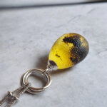 Interlocking Carved Amber Teardrop Pendant - Image 4