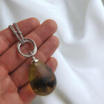 Interlocking Carved Amber Teardrop Pendant - Image 8