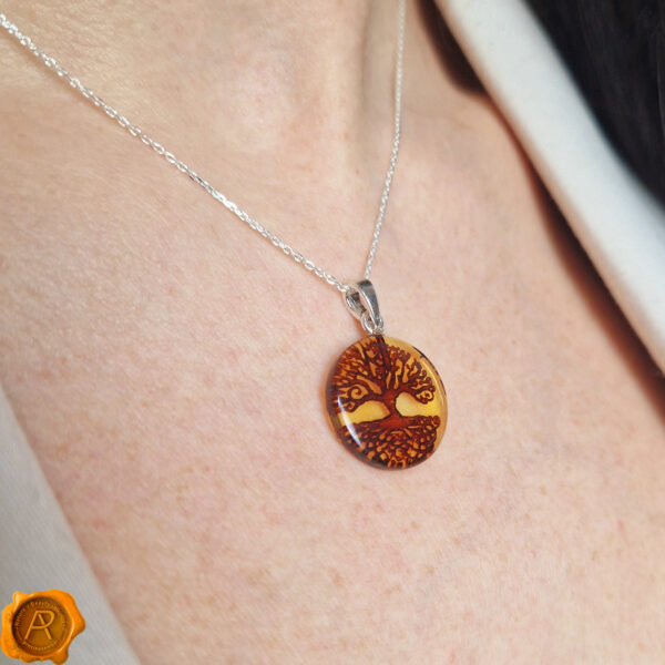This finely detailed pendant features a natural Amber set in 925 Hallmarked Silver with a hand-carved tree of life design. The tree of life symbolizes the connection between all living things, while the Amber represents warmth, healing and vitality. A perfect gift for someone who loves nature and spirituality. 5mm bail space allows adding a necklace of your choice. Whether you wear it for everyday or special occasions, it will add a touch of elegance and charm to your look. Handcrafted to perfection will make a meaningful nature-inspired gift or a wonderful love token for yourself or your special someone. Comes beautifully presented in our signature luxurious grey charcoal Precious Amber jewellery gift box.